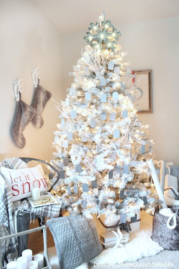 Create a magical rustic modern Christmas display using a white Christmas tree and ombre gray ornaments. The pops of red on this Christmas display keep your eye moving and pulls you in. Such a dreamy setting. 