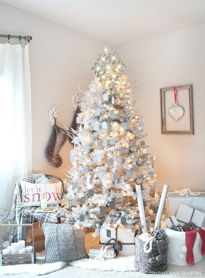 Create a magical rustic modern Christmas display using a gray and white Christmas tree and ombre gray ornaments. The pops of red on this Christmas display keep your eye moving and pulls you in. Such a dreamy setting. 