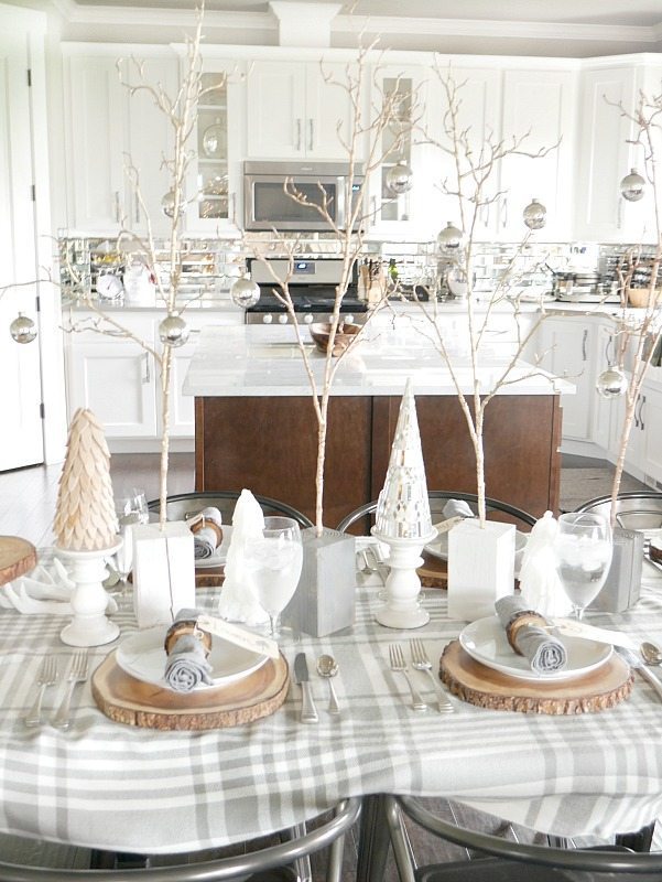 Cozy and Elegant Winter Table Setting with gray and white plaid tablecloth and gold accents