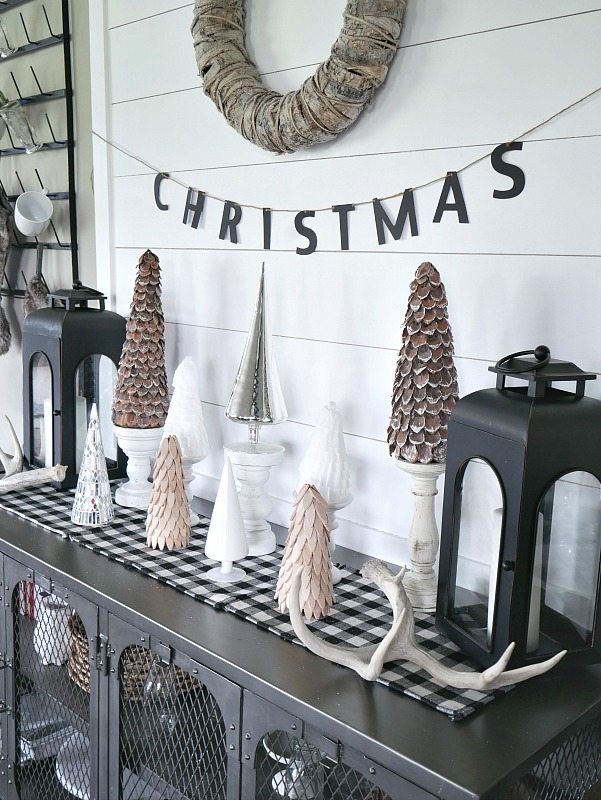 DIY Shiplap Display Wall with a mixture of woodland trees in front! Beautiful natural Christmas Display. 