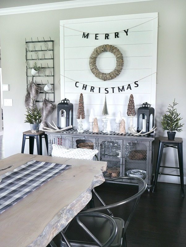 DIY Shiplap Display Wall with a mixture of woodland trees in front! Beautiful natural Christmas Display. 