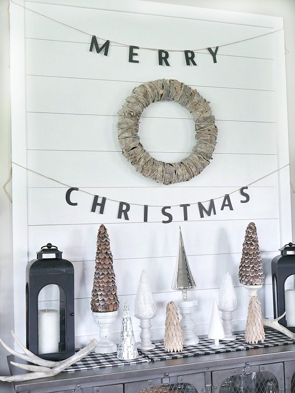 DIY Shiplap Display Wall with a mixture of woodland trees in front! Beautiful natural Christmas Display. 