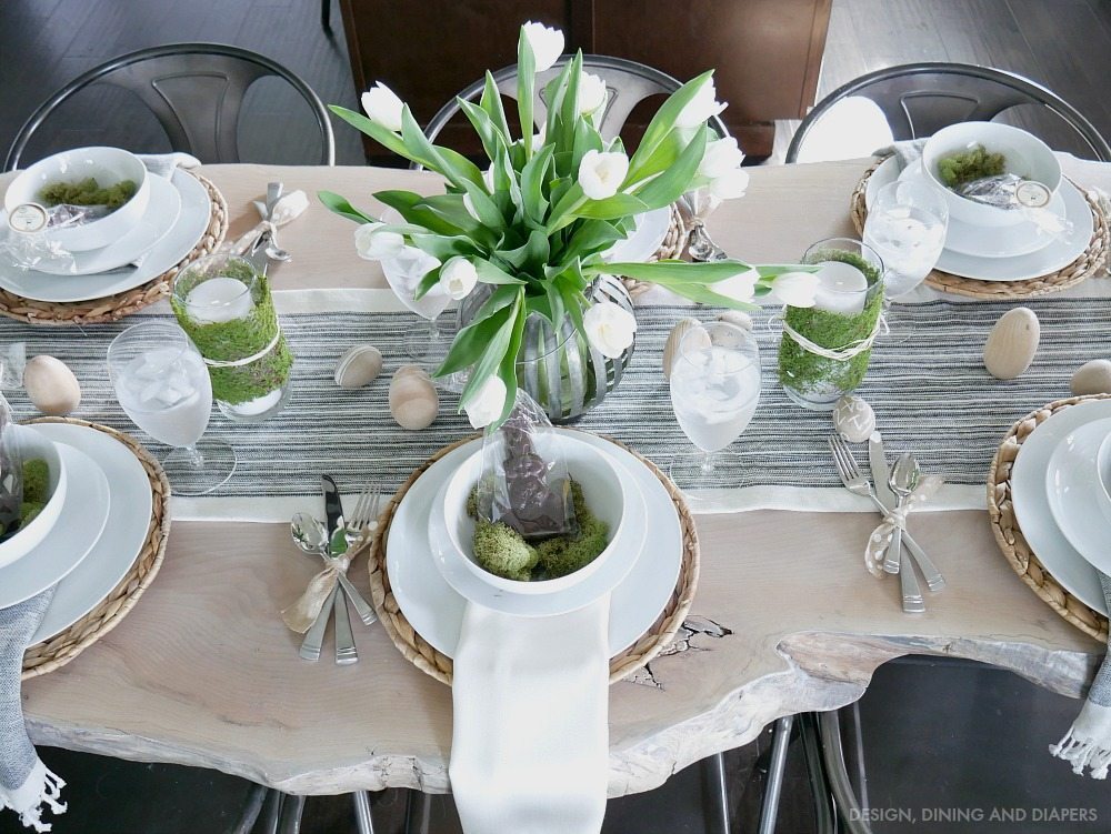 Neutral Easter Tablescape using white tulip centerpiece with chocolate bunnies and natural textures. 