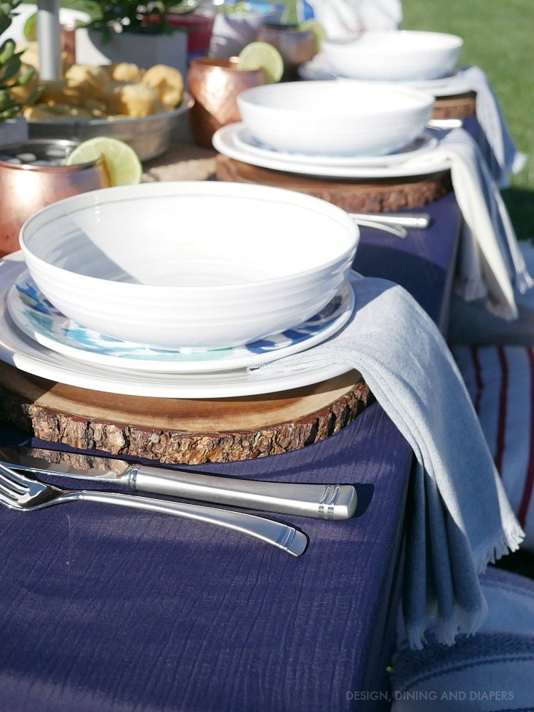 Beautiful outdoor table setting with wood chargers and pretty melamine plates! Keep it casual and chic. 