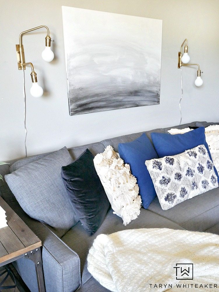 Create a sleek yet cozy space with this modern boho decor look for a small seating area. The mix of black, cream and indigo blue bring a neutral yet bold look to the space.