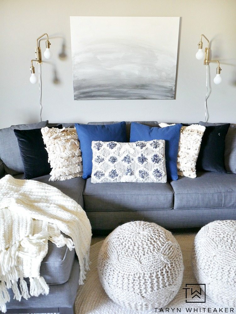 Create a sleek yet cozy space with this modern boho decor look for a small seating area. The mix of black, cream and indigo blue bring a neutral yet bold look to the space.