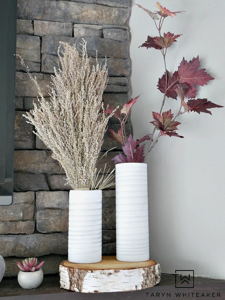 Create a modern boho fall mantel display using a mixture of deep reds, neutrals tones and lots of texture. This is a great look for fall with the earth tones against the stone fireplace. 