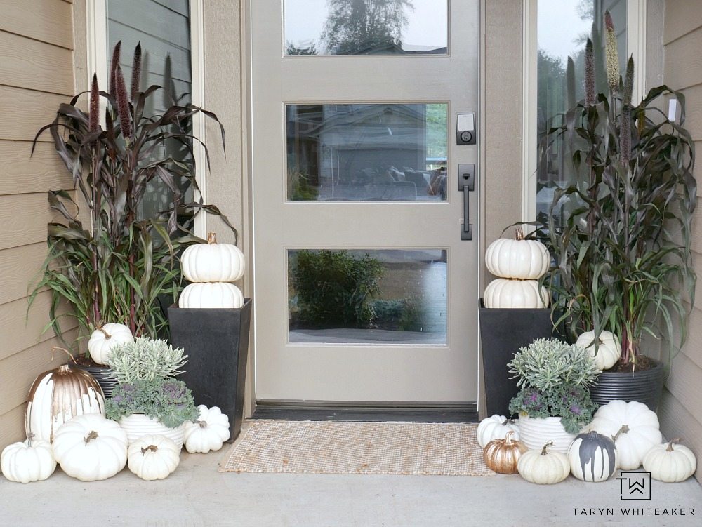 This Elegant Fall Porch design can be easily recreated using millet plants, kale and tons of faux white pumpkins! 