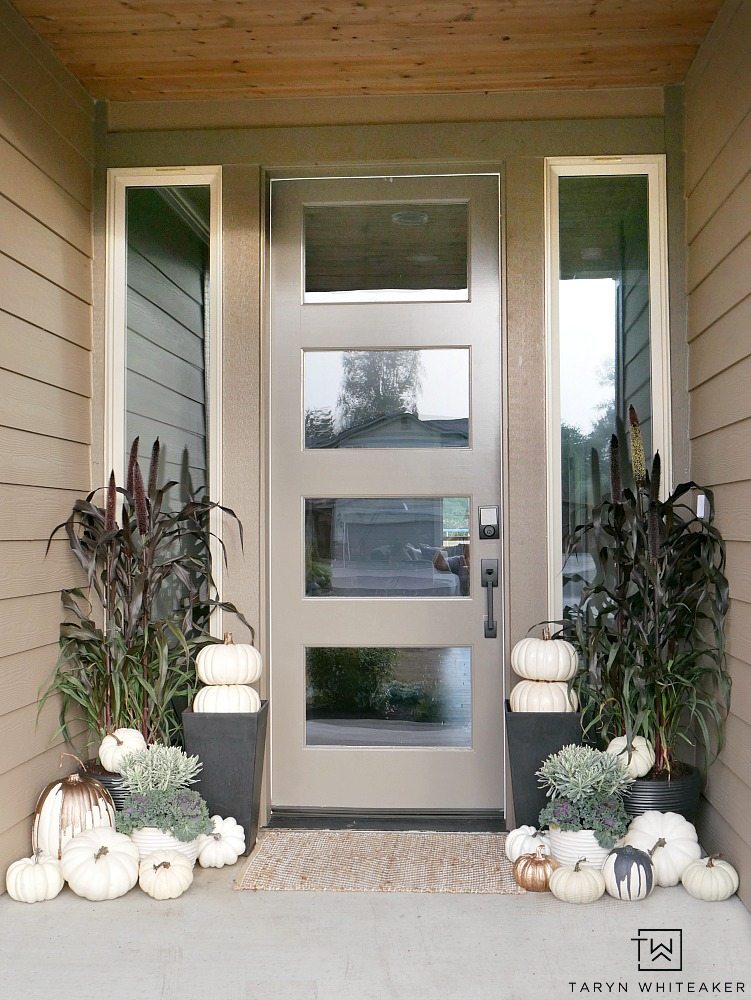 This Elegant Fall Porch design can be easily recreated using millet plants, kale and tons of faux white pumpkins! 