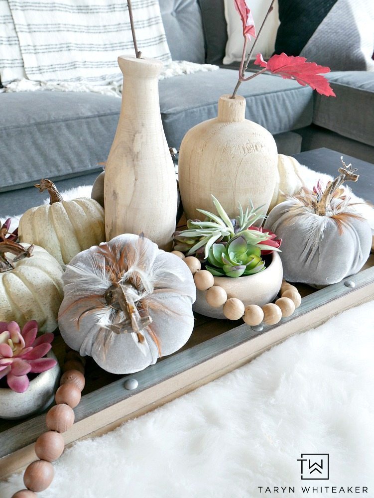 For this piece, it was all about layersing and adding complimentary pieces together to create a Modern Boho Fall Centerpiece. I started with this wood and galvanized tray and built from there. Then, I started to fill it with these beautiful gray velvet pumpkins with feathers, these mini rose gold succulents (which I have fallen in love with), and some white pumpkins. 