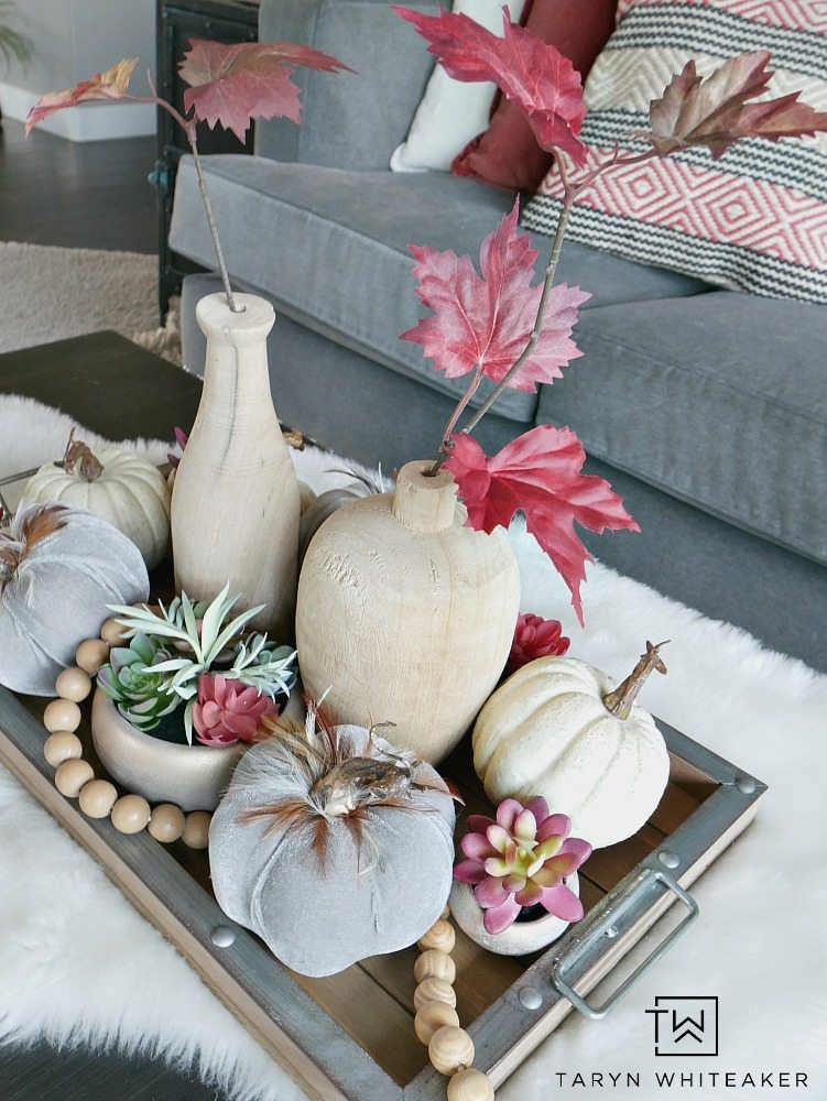 For this piece, it was all about layersing and adding complimentary pieces together to create a Modern Boho Fall Centerpiece. I started with this wood and galvanized tray and built from there. Then, I started to fill it with these beautiful gray velvet pumpkins with feathers, these mini rose gold succulents (which I have fallen in love with), and some white pumpkins. 