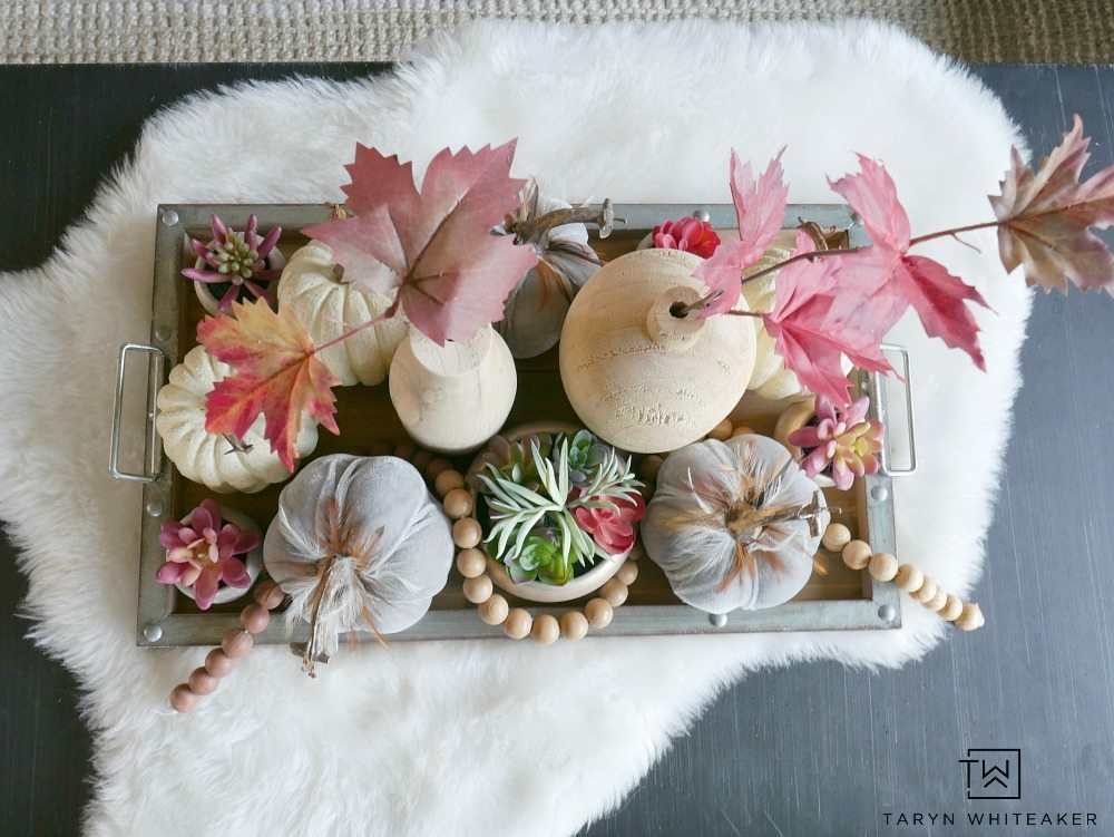 For this piece, it was all about layersing and adding complimentary pieces together to create a Modern Boho Fall Centerpiece. I started with this wood and galvanized tray and built from there. Then, I started to fill it with these beautiful gray velvet pumpkins with feathers, these mini rose gold succulents (which I have fallen in love with), and some white pumpkins. 