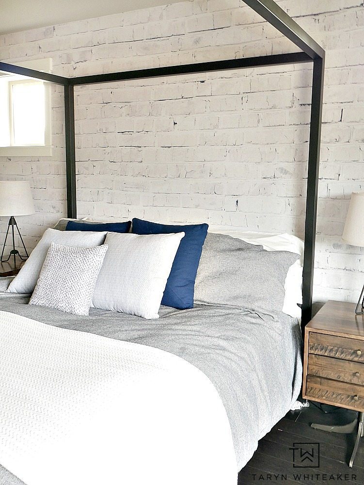 Give your room dimension by adding an accent wall using a white washed brick wall mural from Walls Need Love. This is a removable wall mural that won't damage your walls and is so easy to install. Loving the Rustic Modern look it gives this room. 