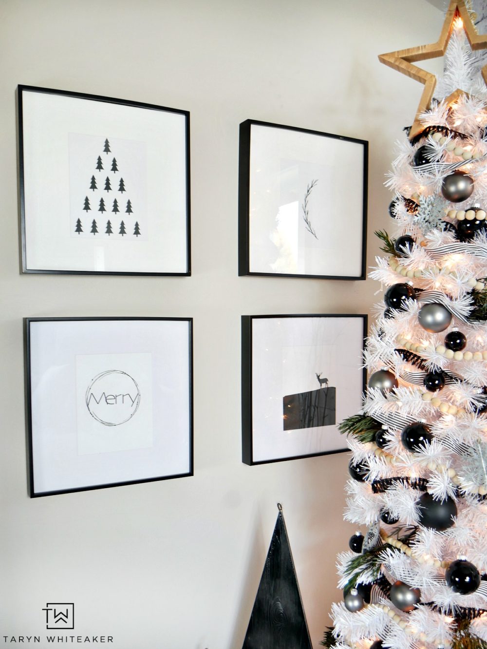 Taryn creates this Modern Black and White Christmas Tree display in her home using a tall white skinny tree with black and silver ornaments and wood!