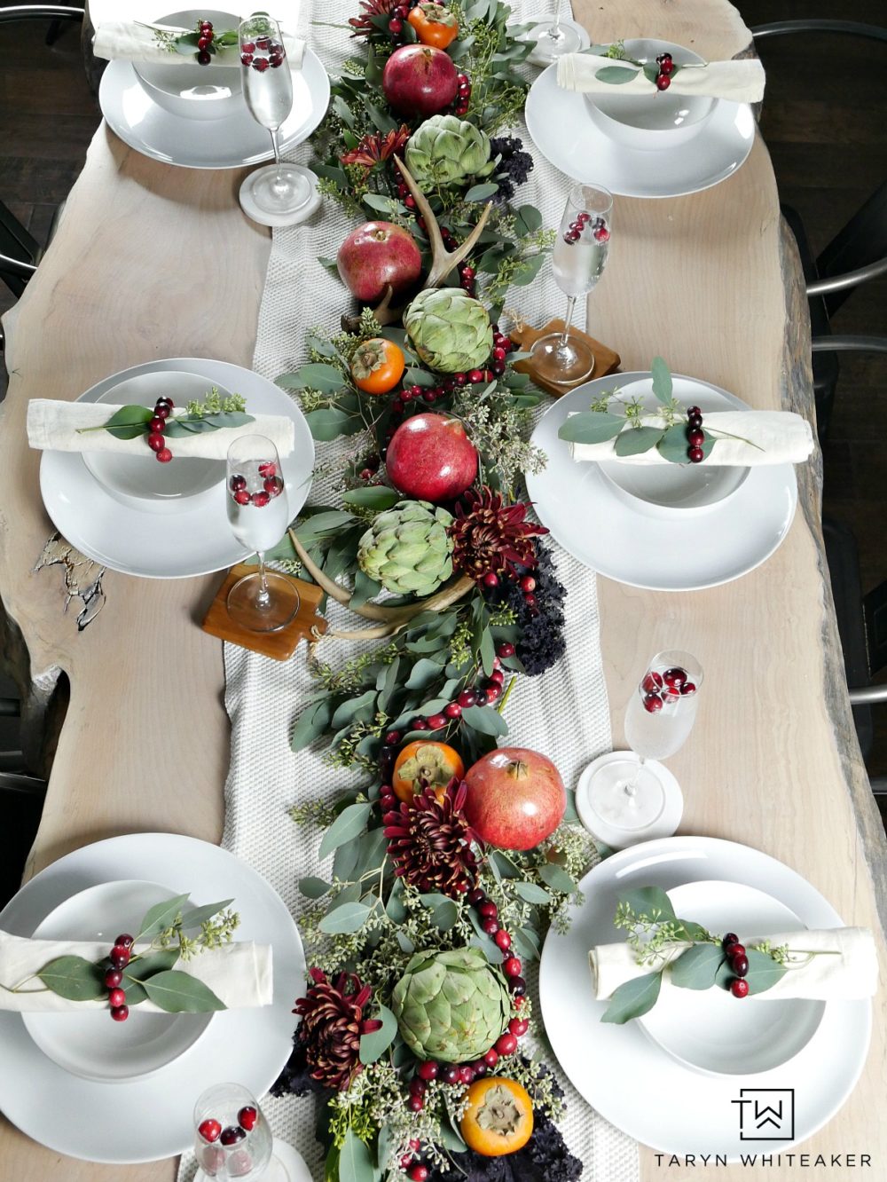 Gorgeous and classy fall table decor using pomegranates, artichokes and cranberries. Love all the natural colors of all brought into this table. 