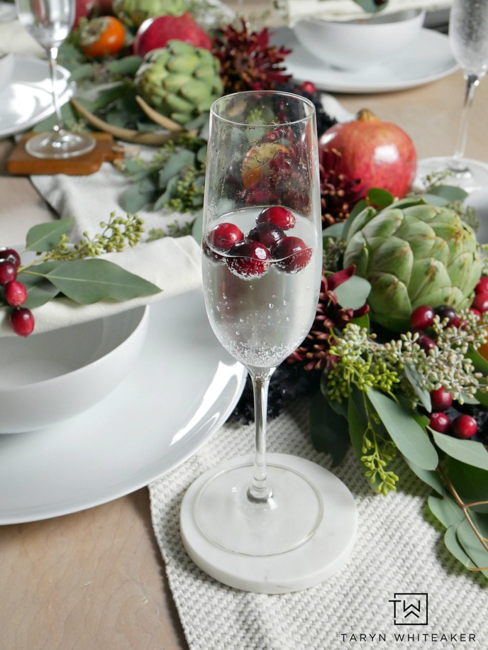 Thanksgiving tablescape featuring cranberries floating in champagne glasses