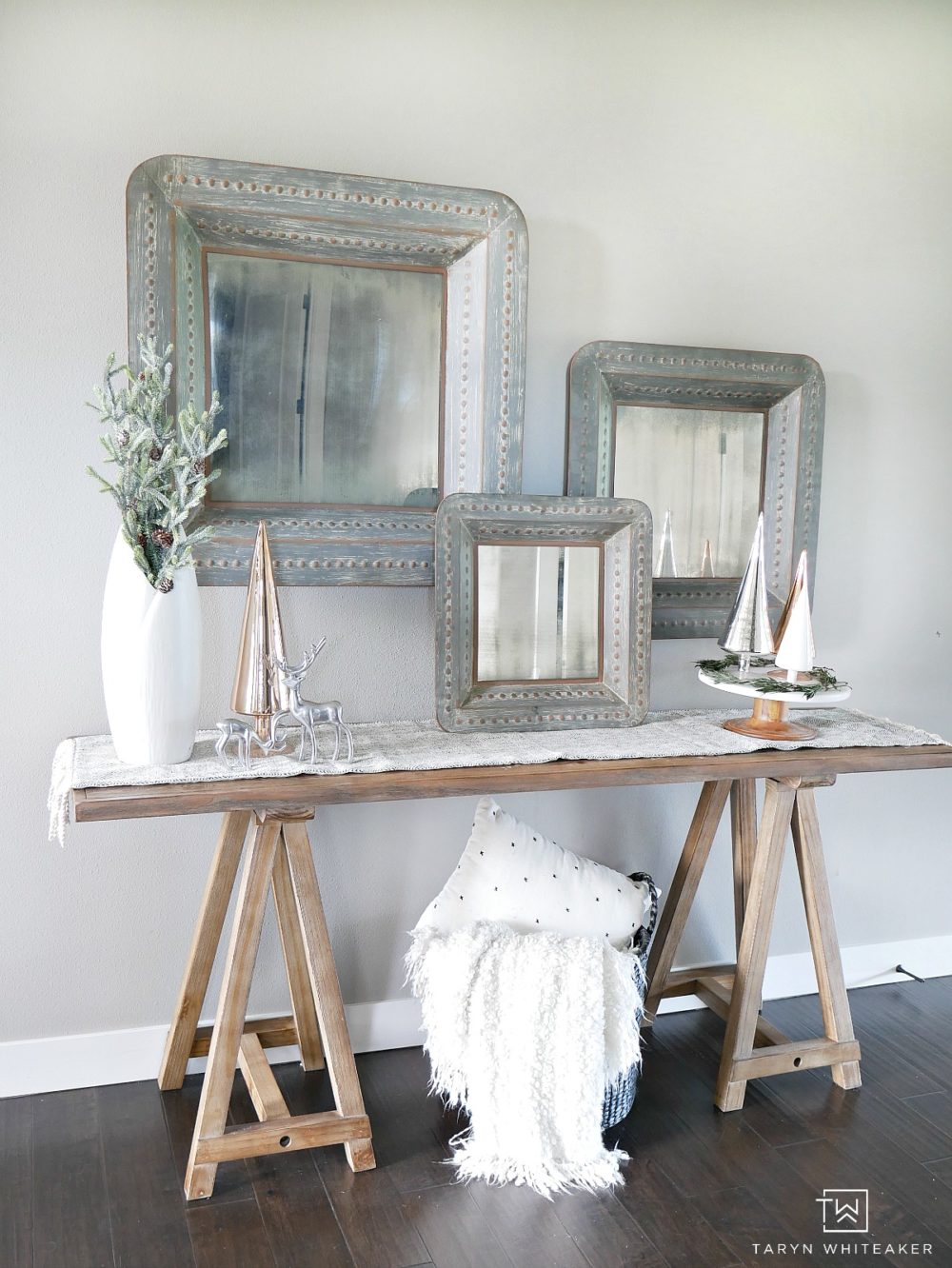 Make subtle touches to your entry way to create this Chic Christmas Entry Way using rustic metals, distressed wood paired with metallic trees and greener!