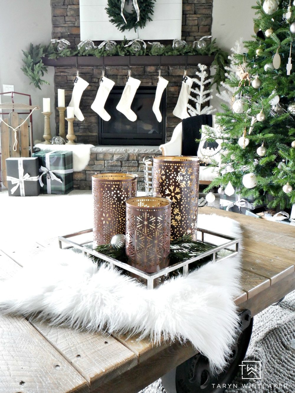 Recreate this Neutral Christmas Mantel using lush greenery, winter white and pops of black and plaid. This look is fresh, clean and festive. 