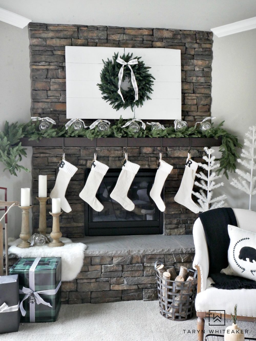 Recreate this Neutral Christmas Mantel using lush greenery, winter white and pops of black and plaid. This look is fresh, clean and festive. 