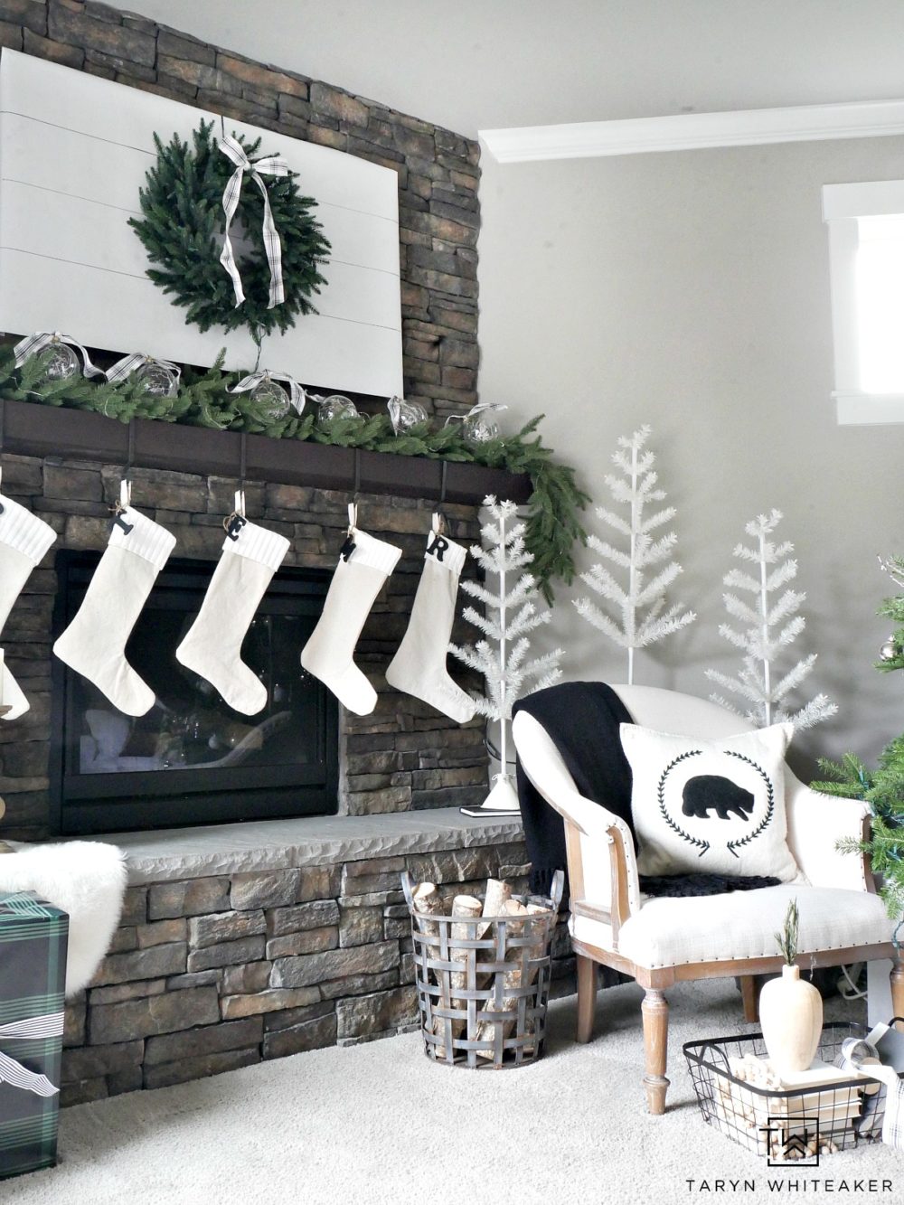 Recreate this Neutral Christmas Mantel using lush greenery, winter white and pops of black and plaid. This look is fresh, clean and festive. 
