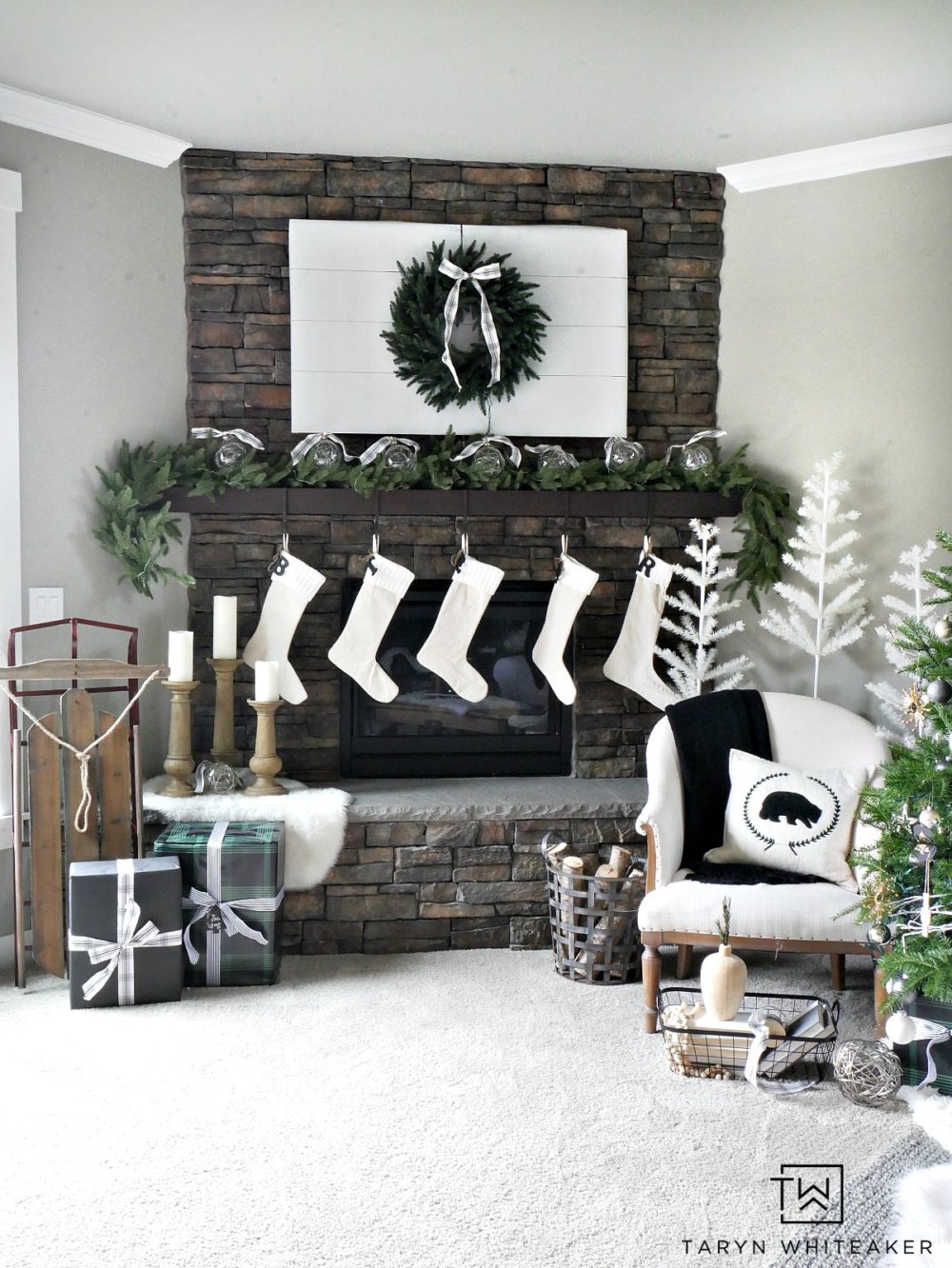 Recreate this Neutral Christmas Mantel using lush greenery, winter white and pops of black and plaid. This look is fresh, clean and festive. 