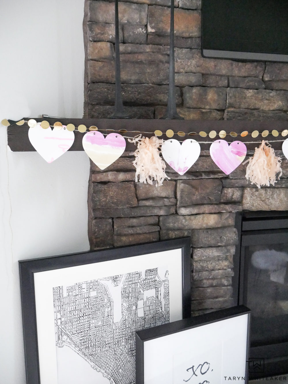 Learn how to create this Simple Valentine's Day Mantel using your kids' artwork! It's always fun to add a little festive cheer to your home especially with handmade art!