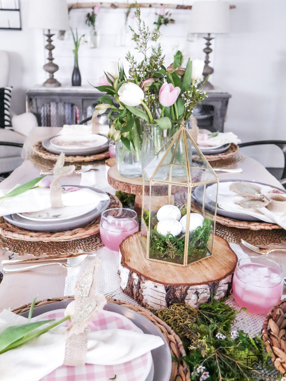 Garden themed Easter table with pink and green accents! Fresh moss centerpiece with wood rounds gives it a rustic touch. 