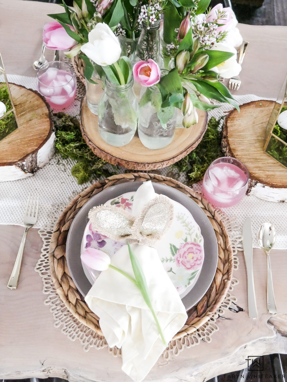 Looking for fresh Easter Table Ideas? Easily recreate this Enchanting Pink and Green Easter Table that incorporate lots of moss and wood rounds with pops of fresh flowers!