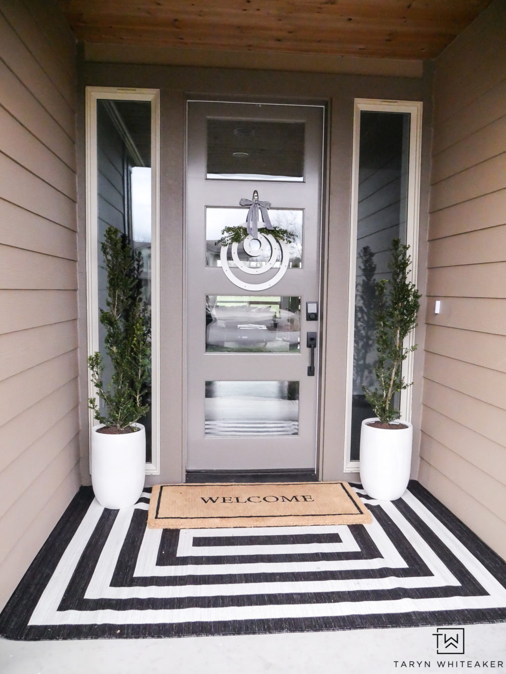 A classic yet modern take on a spring porch! The black and white rug with the modern planters  is simple yet so pretty. 