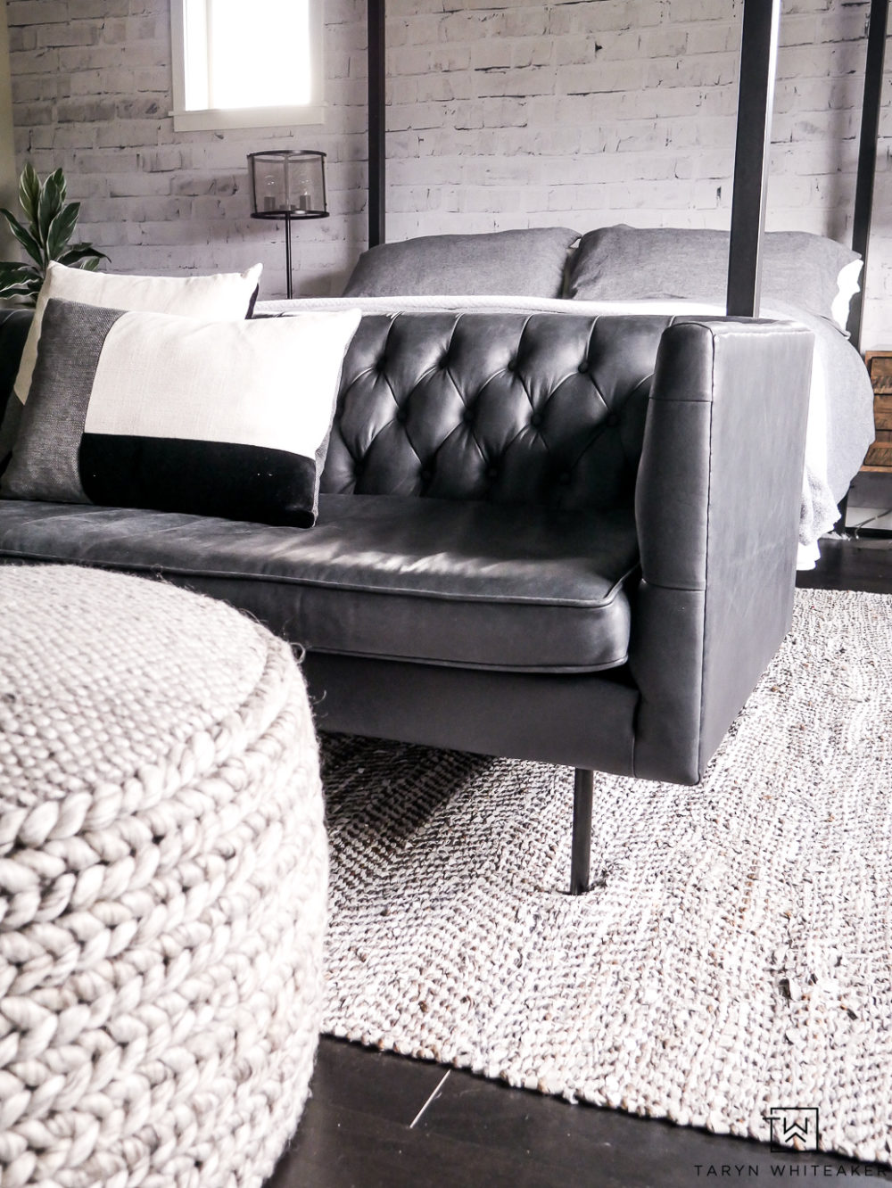 Love this modern black leather chesterfield sofa for an industrial master bedroom seating area. 