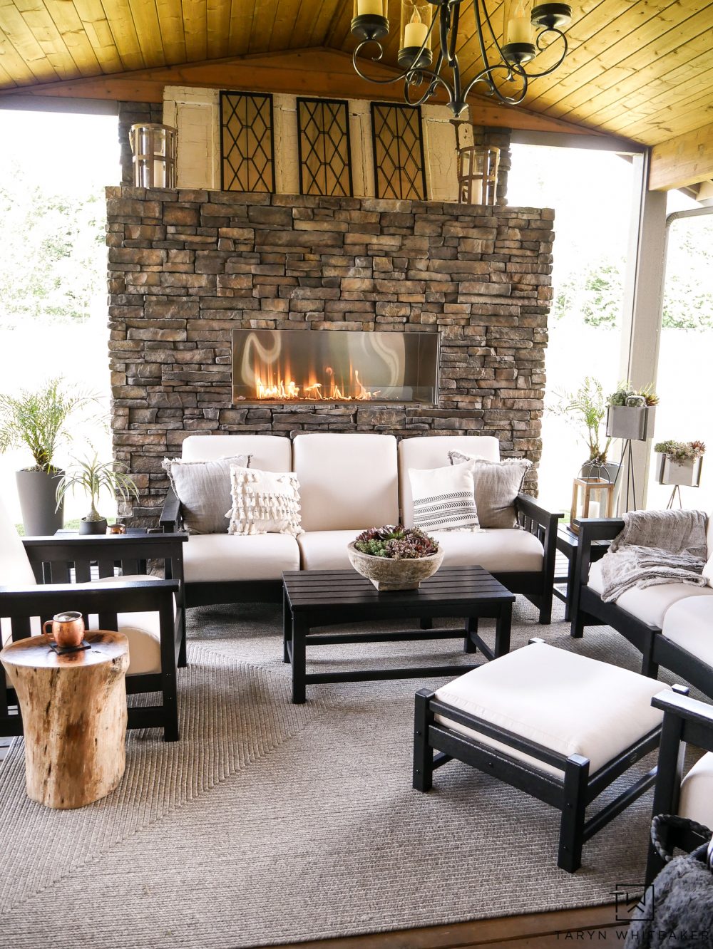 This gorgeous Black and White Outdoor Furniture makes this space feel so luxurious. The neutral tones with the stone fireplace create a soft and cozy living space. 