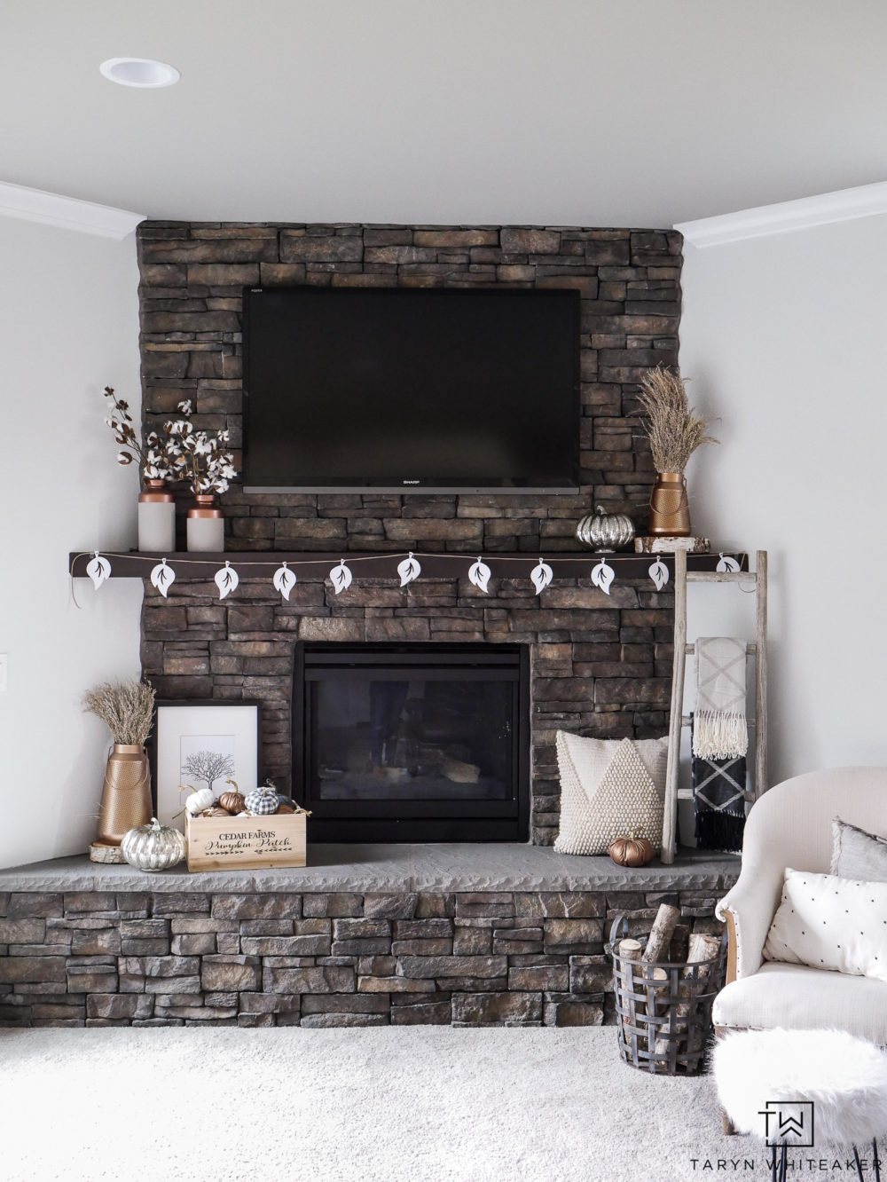 Dress up your family room for fall with this rustic yet chic neutral and copper fall mantel decor. Get the look by mixing lots of textures and metals!