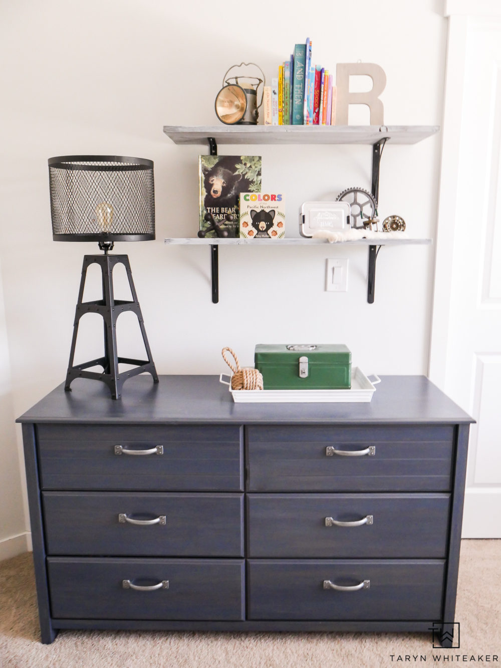 Navy blue dresser with open shelving for a boys room. 