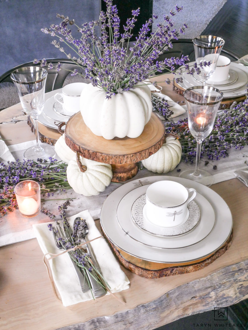 Create a classy and elegant Lavender Fall Tablescape filled with blooms from your own yard! Give it a fall look using white pumpkins and tea light candles. 