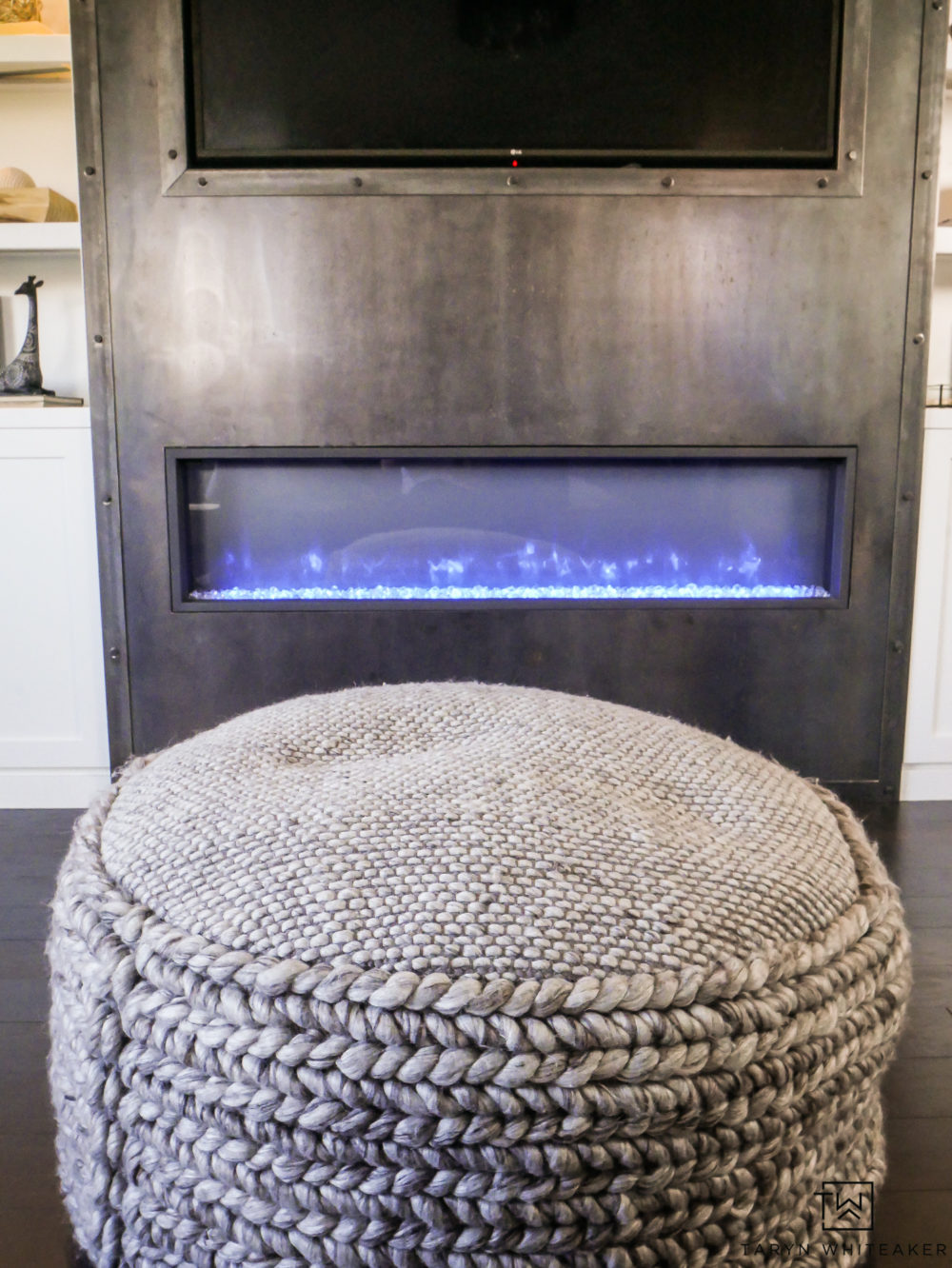 Custom raw steel fireplace with electric fireplace and industrial bolt trim. 