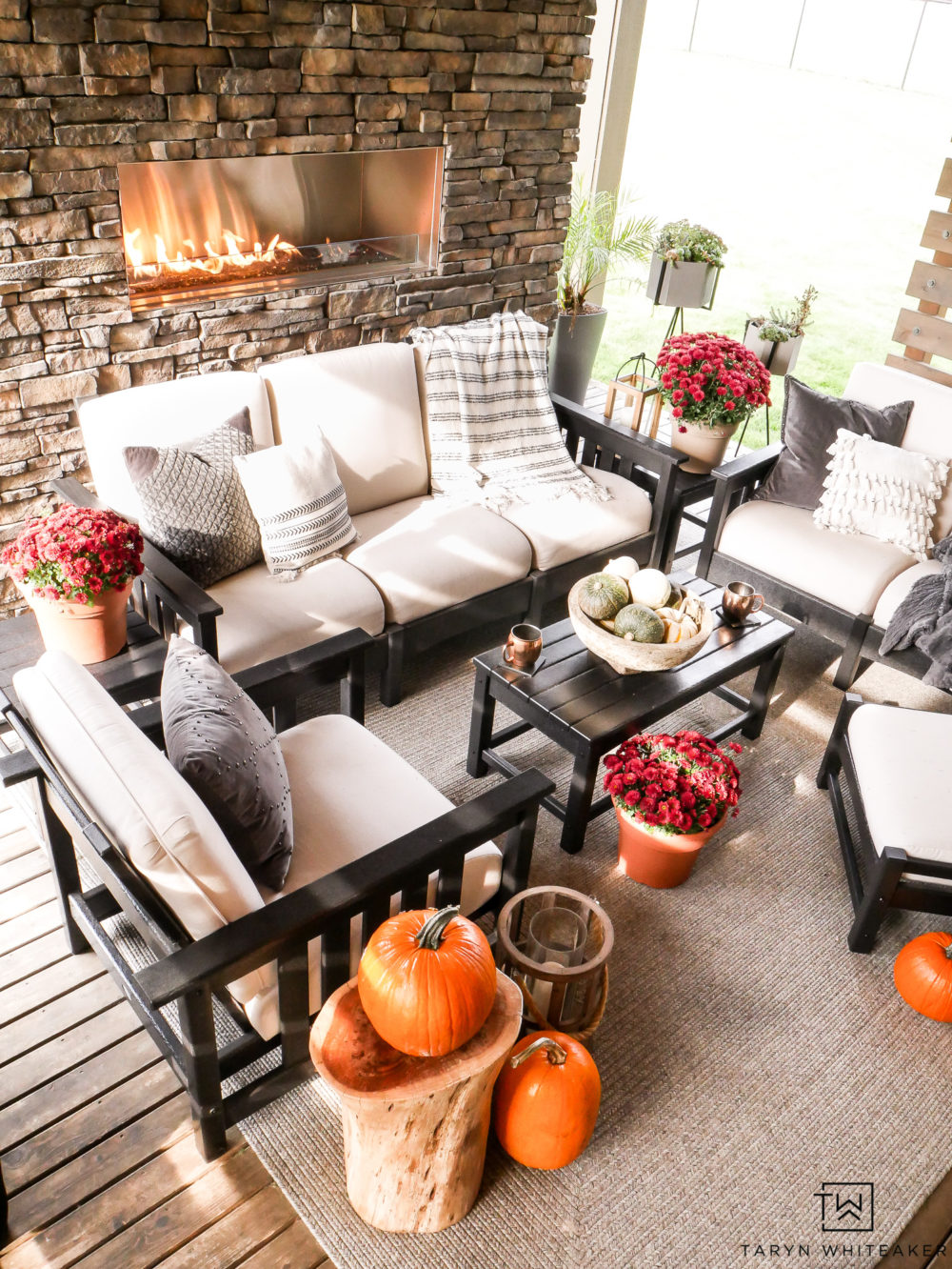 Outdoor Living Space all decorated for fall with natural stone fireplace and pumpkins throughout! Keep it simple but festive. 