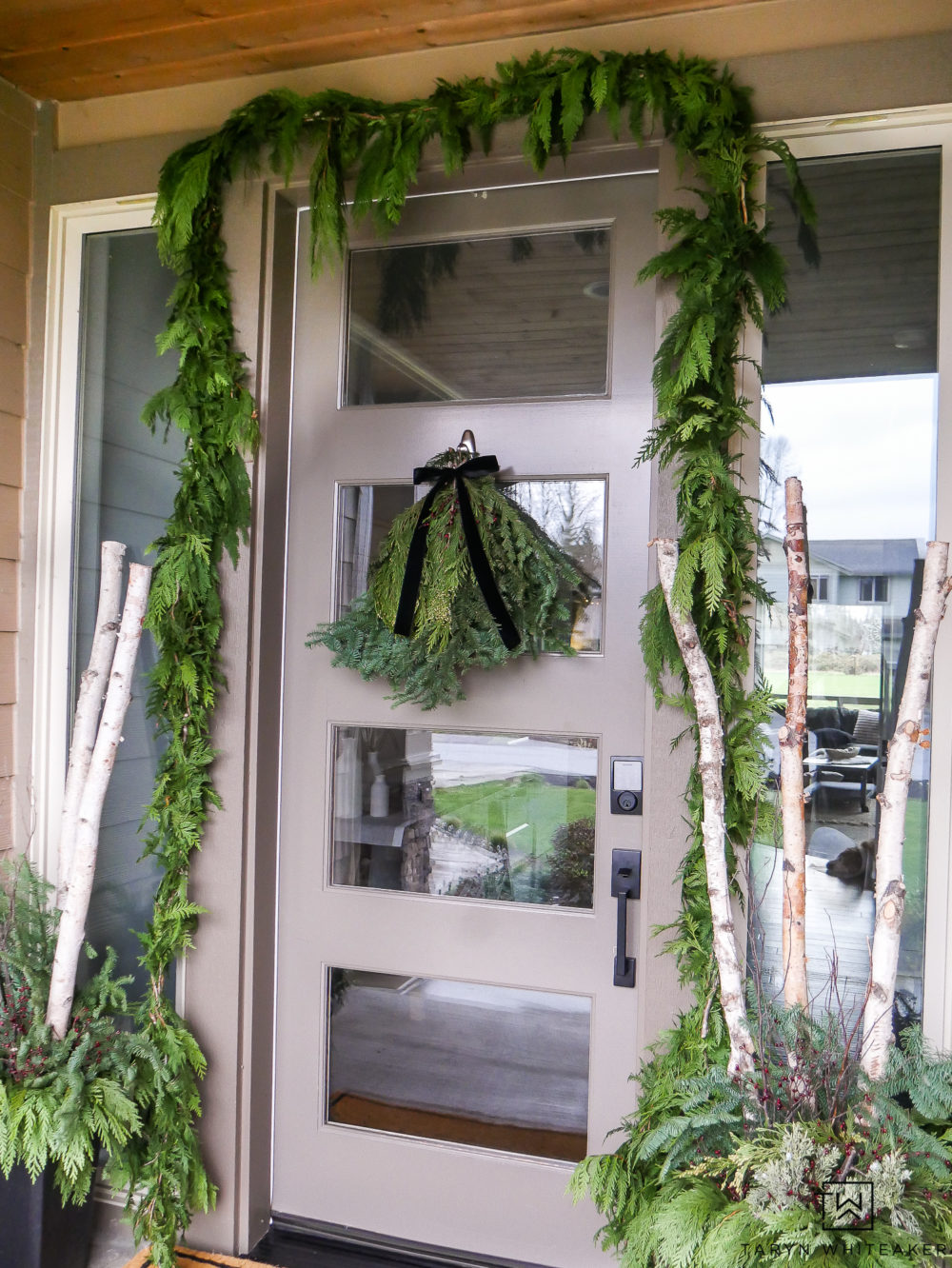 Hang fresh garland around your front door for the holidays. Simple greens from grocery store can make such a difference!