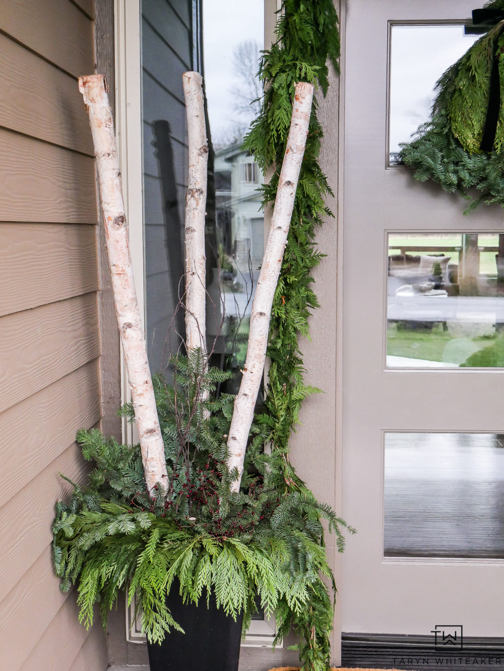 Create your own DIY Christmas Planters filled with fresh greens and birch logs. Love this traditional yet modern look for the holidays. 