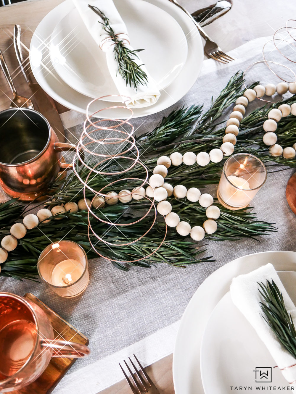 Simple Christmas centerpiece ideas using greenery, natural wood and pops of copper. 