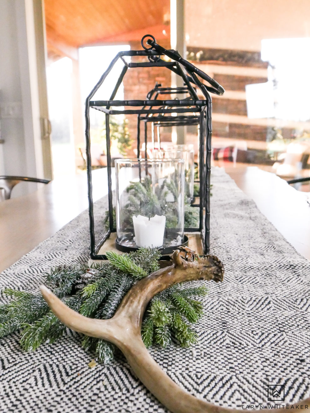 Black and White Christmas Centerpiece using lanterns and greenery