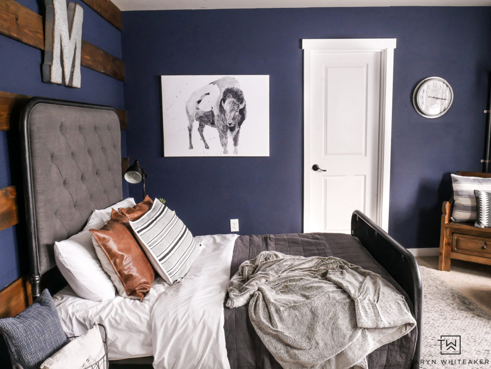 Awesome boy room design using dark navy walls and industrial decor. 