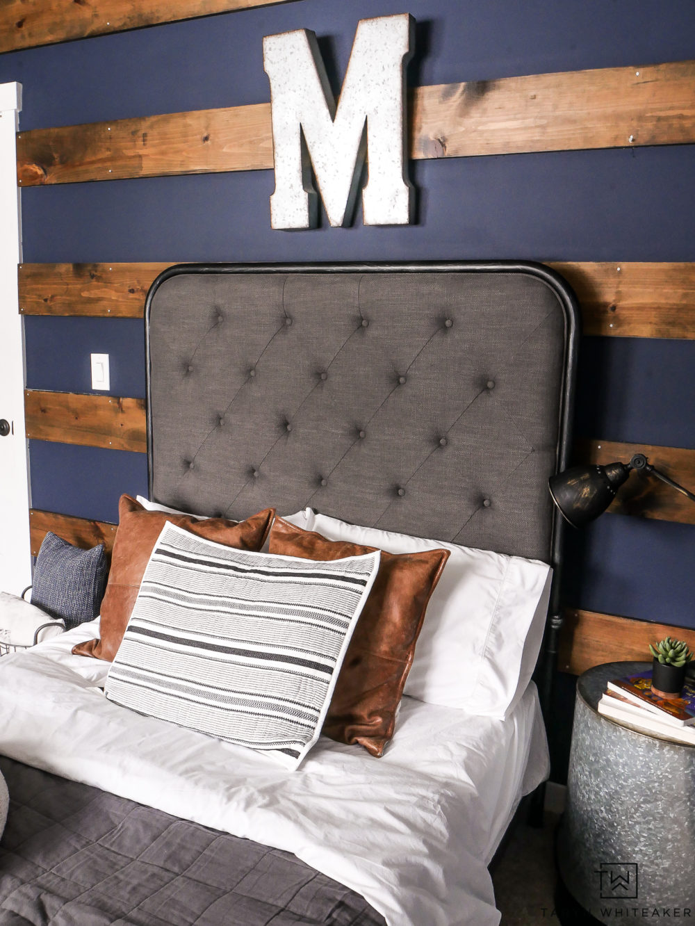 Industrial boy's room with wood striped wall and navy walls. 