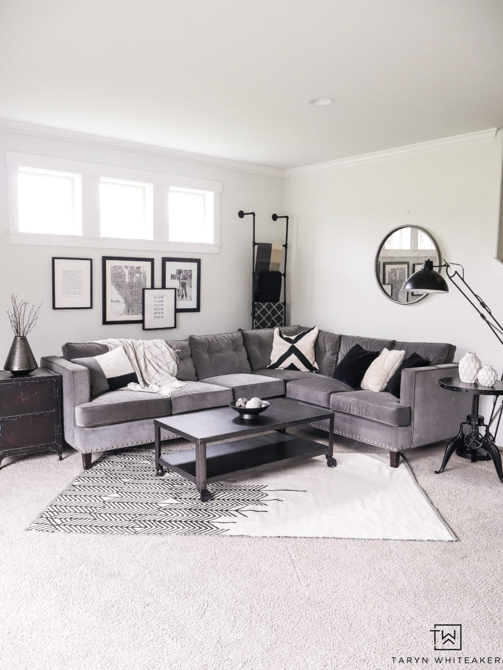 Gray sectional with with black and white decor. Ideas for how to style a corner sectional. 