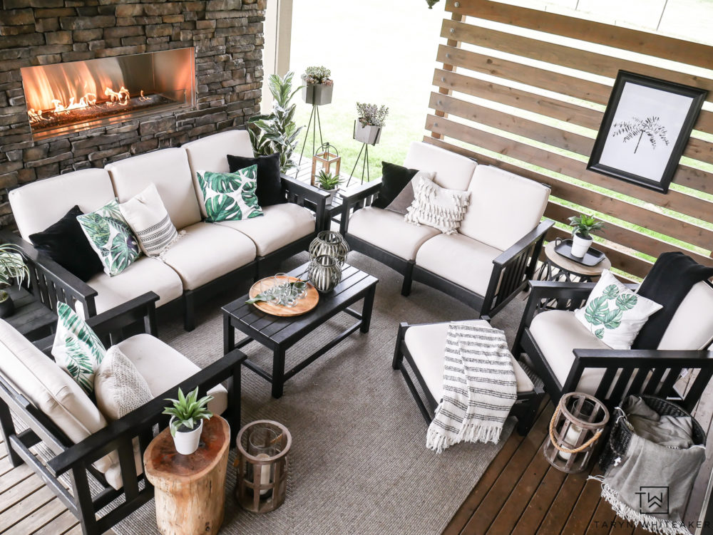 Black and White Outdoor living space with pops of tropical palms. Great take on Modern Coastal Decor. 