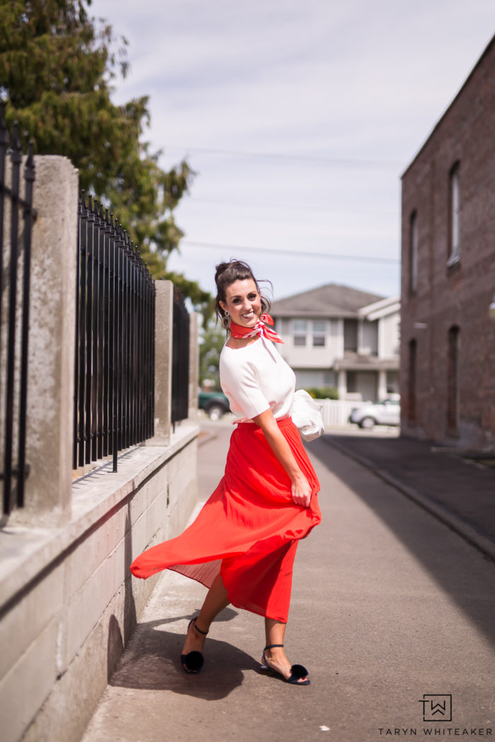 Do a little twirl in this red pleated midi-skirt and white sweater top. The scarf gives it a classic yet trendy look for summer. 