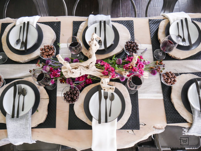 Beautiful rustic modern table design featuring natural elements from drift wood centerpiece with farm fresh flowers and wood charger. 