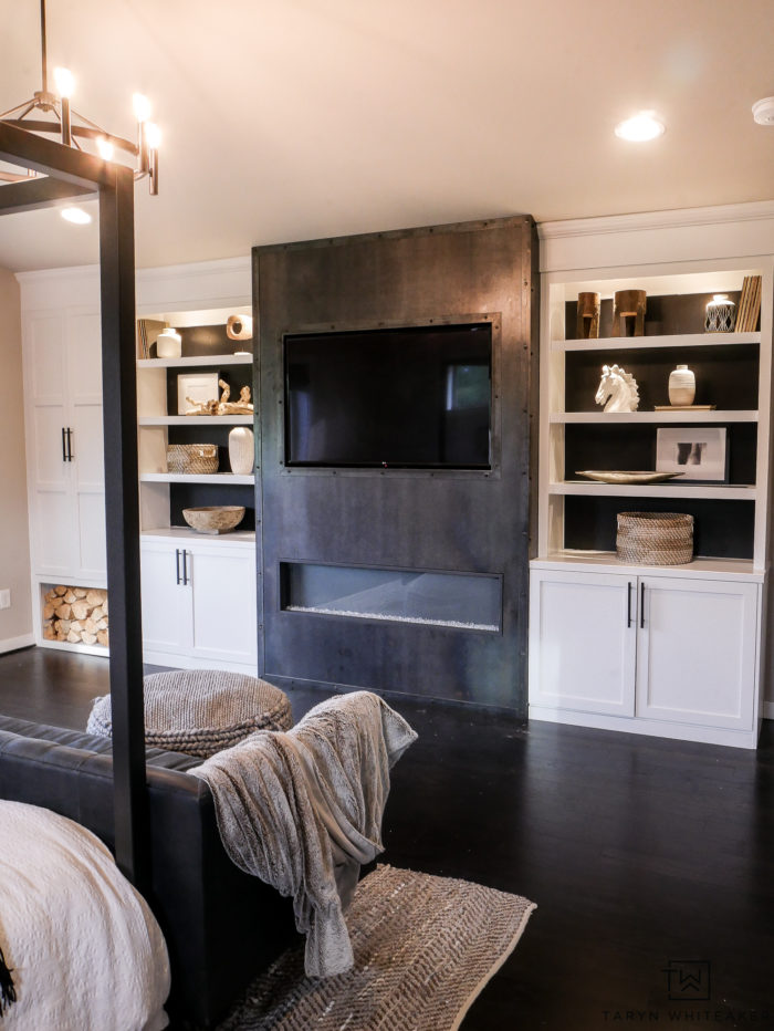 Custom luxe builtins in the master bedroom with a steel fireplace and white builtins with black background. Such a great modern contemporary look for a high end look. 