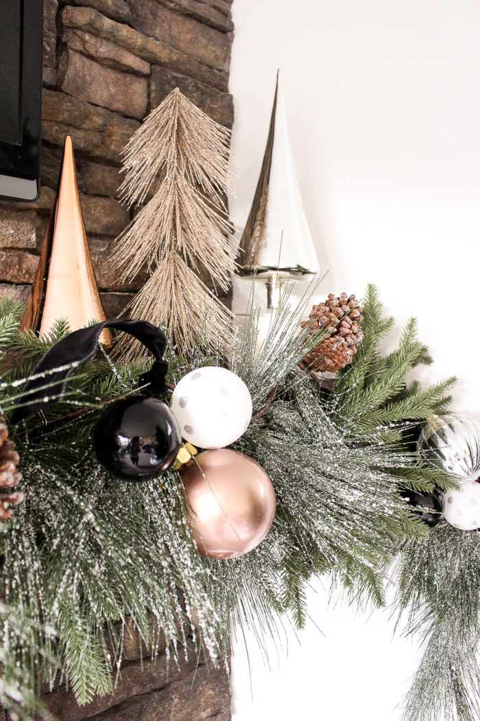 Learn how to create this elegant and simple christmas mantel using black amnd white holiday decor with pops of rose gold and metallics!