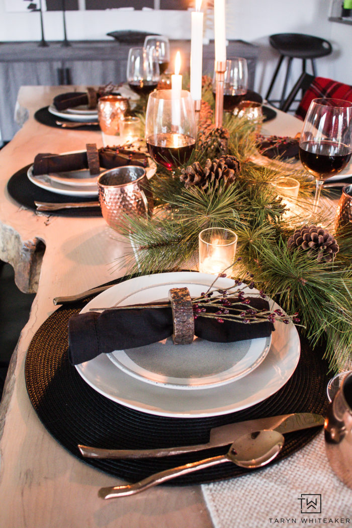 Combine rustic natural elements and a little Christmas glam to create this sleek Rustic Chic Christmas Table with black and white dishes and pops of greens.