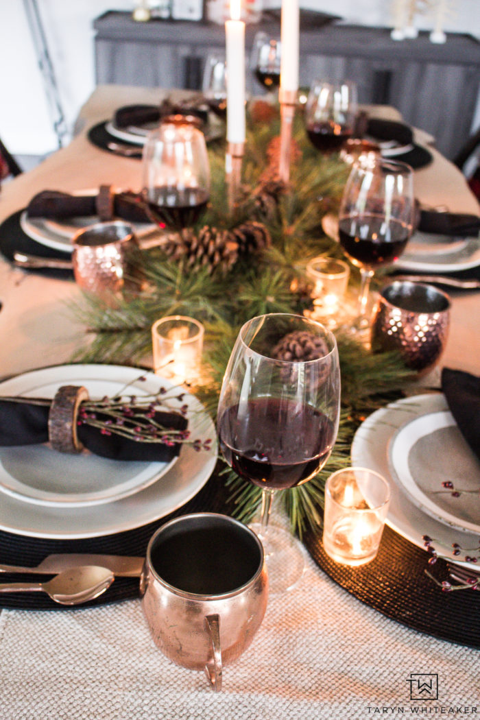 Combine rustic natural elements and a little Christmas glam to create this sleek Rustic Chic Christmas Table with black and white dishes and pops of greens.